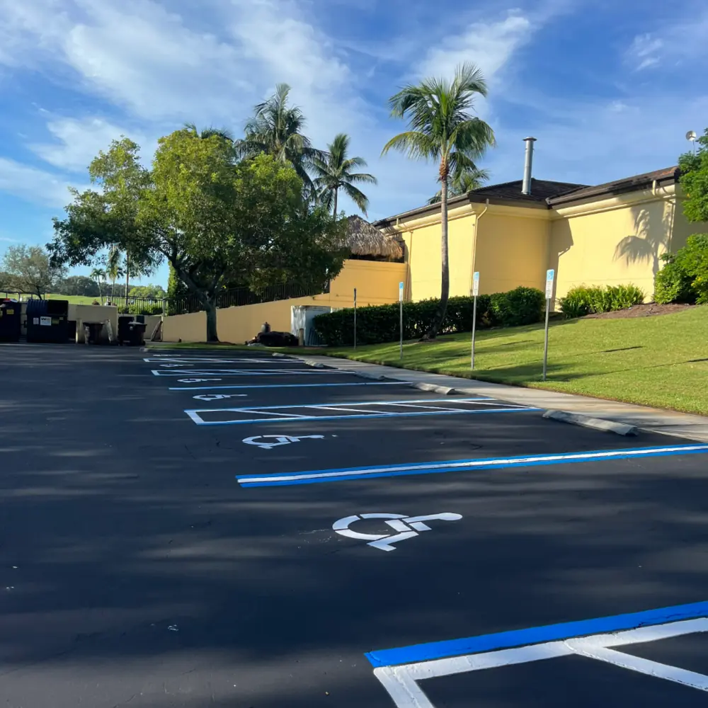 Freshly sealcoated and striped parking lot with ADA accessible stalls at Lely Golf Resort in Naples Florida