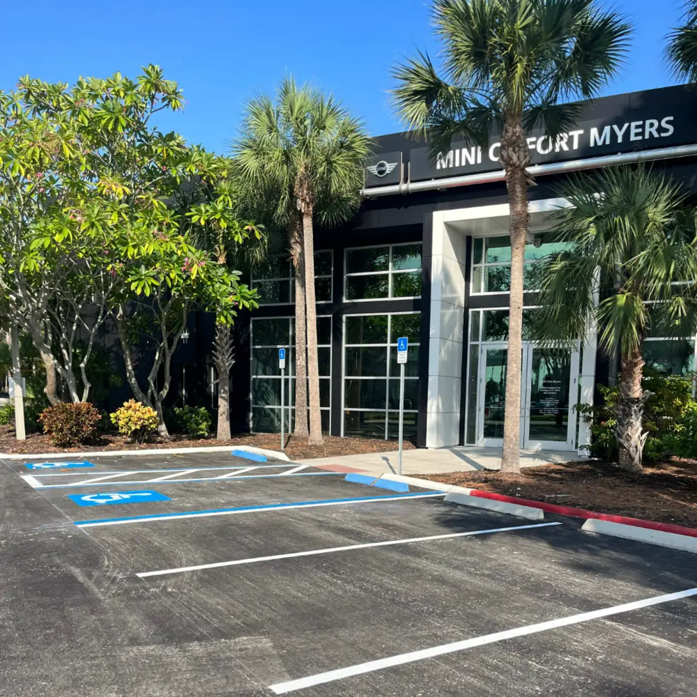 Freshly striped parking lot with ADA accessible stalls at the MINI of Fort Myers dealership in Fort Myers Florida