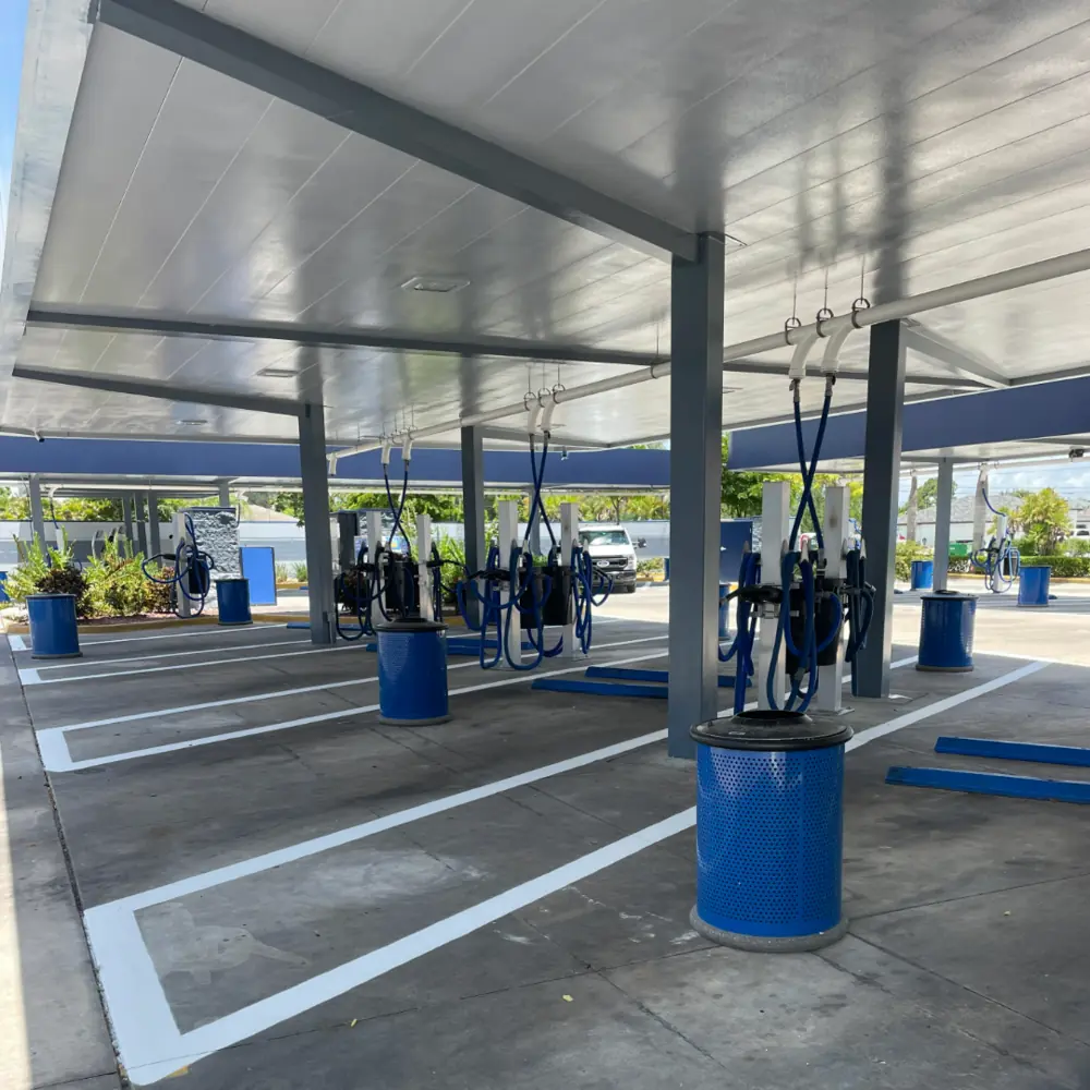 Freshly striped parking stalls at a Mister Car Wash vacuum area in Southwest Florida