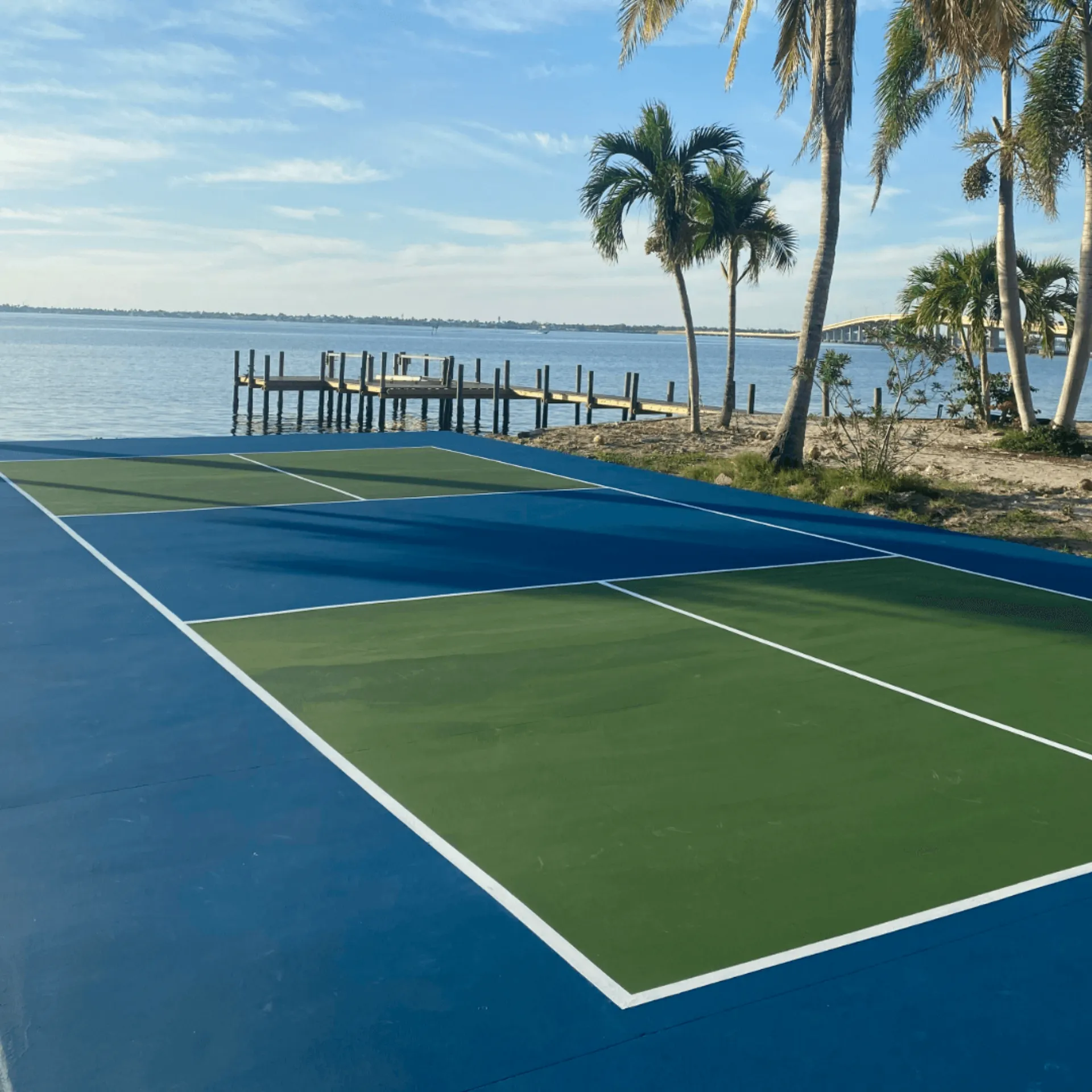 Waterfront pickleball court in Southwest Florida with blue and green acrylic surface